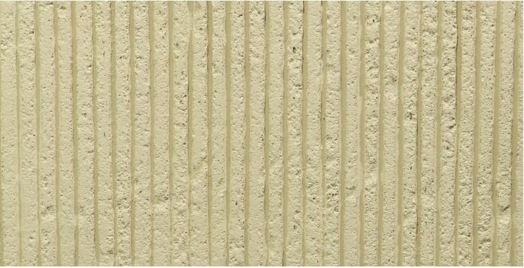 Cut Stone flexible clay cladding with chiselled vertical fluting wrapped around a round column